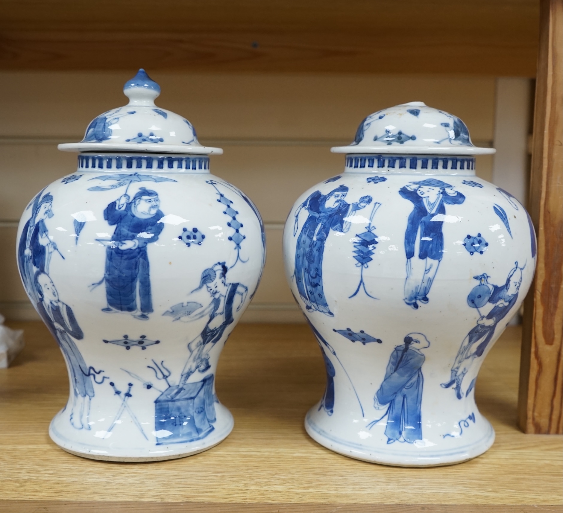 A pair of Chinese blue and white ‘street performers’ baluster vases, circa 1900, 25cm. 25.5cm. Condition - damaged